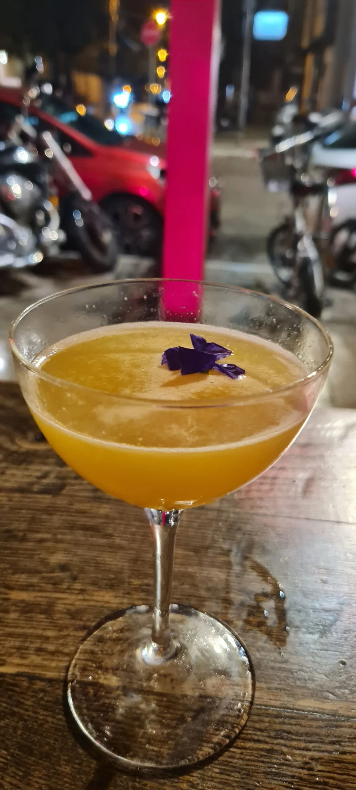 Orange Cocktail with Edible Flower Garnish