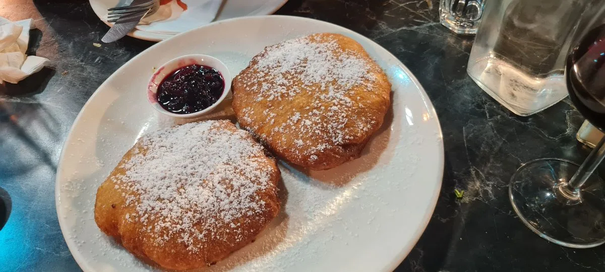 Fried Dough with Powdered Sugar and Berry Compote